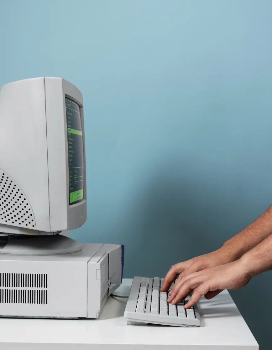 Frame 40 Person typing on vintage CRT computer with green-on-black terminal interface