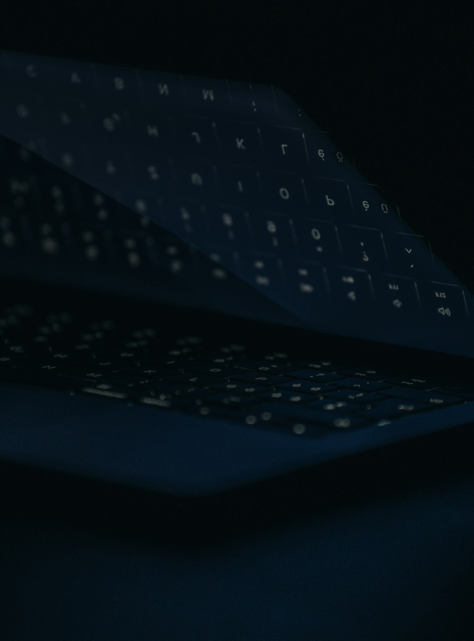 Frame 41 Dark laptop with glowing Cyrillic keyboard overlay
